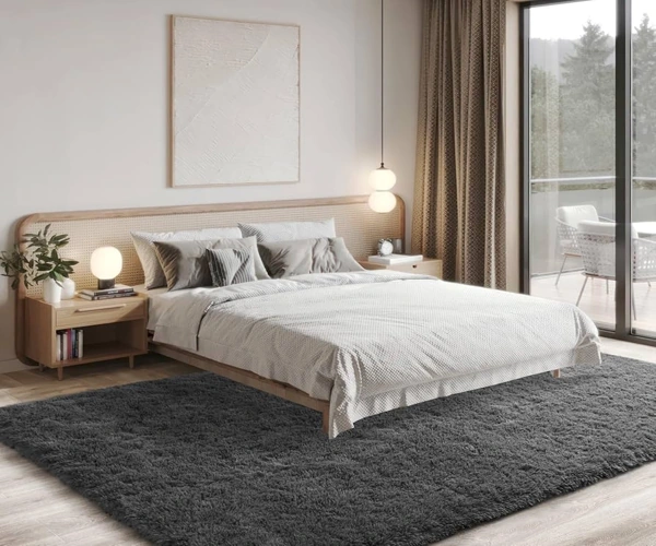 Soft dark grey shag rug in a bright modern bedroom.