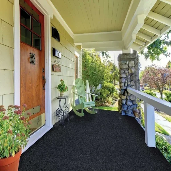 Black textured outdoor carpet on a porch.