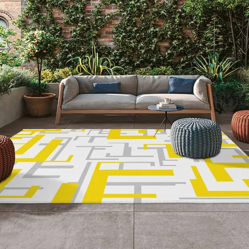 Navy and beige outdoor carpet bringing a touch of luxury to a patio space.