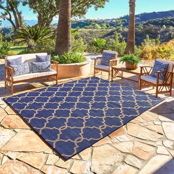 Patterned outdoor rug on Dubai patio, desert tones, durable, stylish.