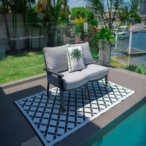 Water-resistant rug creating comfortable seating area on deck