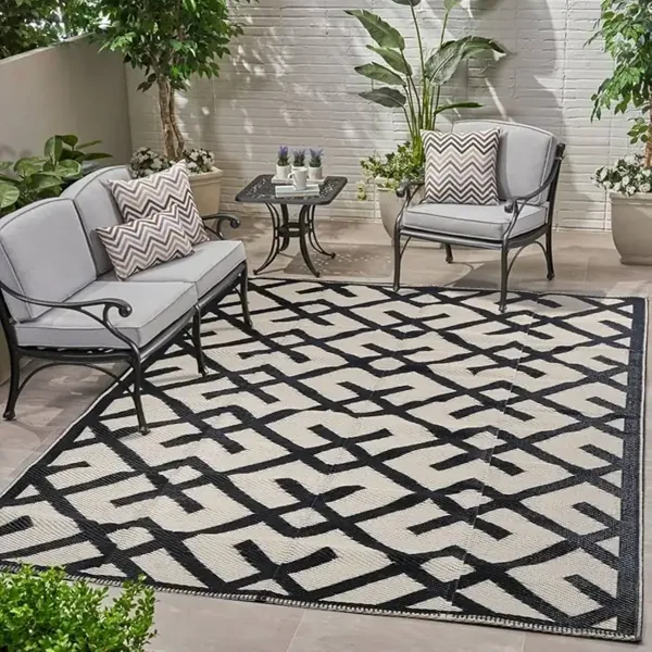 outdoor rug with a geometric trellis pattern on a patio.